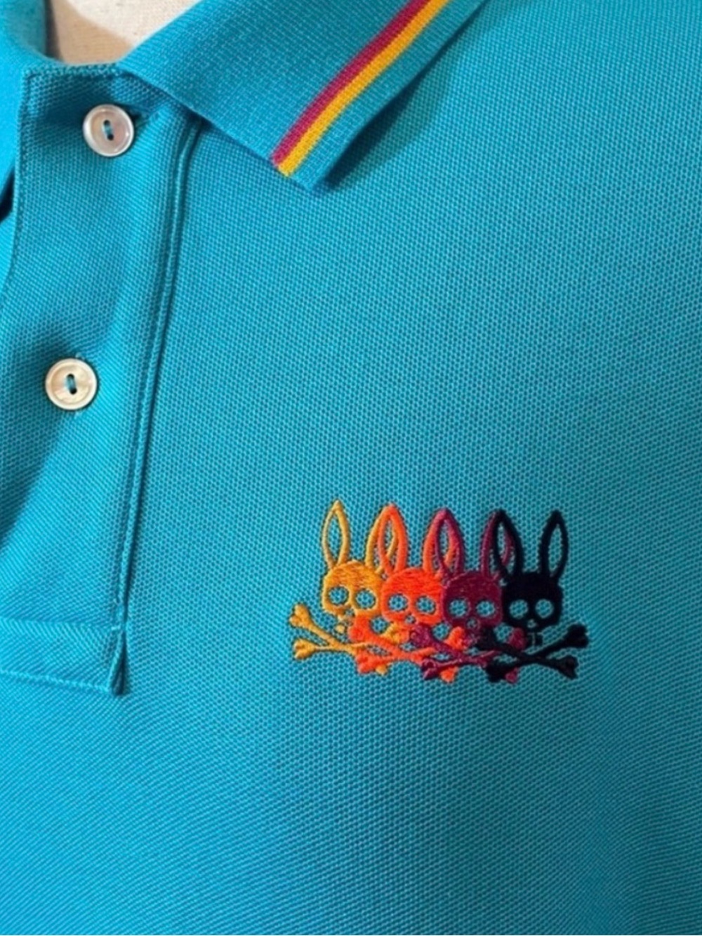 Psycho Bunny Teal Polo with Multicolor Skull-Bunny Embroidery